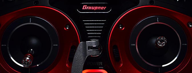 The Graupner logo and power button glow red. The logo changes to blue when transmitting RF.